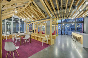 a dining room with tables and chairs and a building in the background at L Seven, San Francisco, California 94103