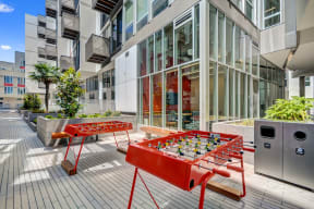 a foosball table on a patio in front of a building at L Seven, California, 94103