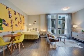 a bedroom with a bed and a living room with a table and chairs at L Seven, San Francisco, CA