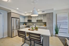 a kitchen with a large island and a stainless steel refrigerator at L Seven, California, 94103