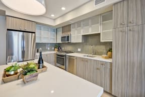 a kitchen with stainless steel appliances and white counter tops at L Seven, San Francisco, California 94103