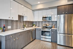 a kitchen with stainless steel appliances and white cabinets at L Seven, California, 94103
