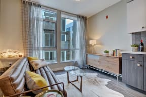 a living room with a couch and a large window at L Seven, San Francisco