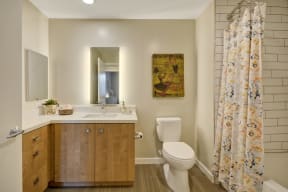 a bathroom with a toilet and a sink and a shower curtain at L Seven, San Francisco, CA
