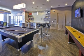 a games room with a pool table and a tv at Mockingbird Flats, Dallas, TX