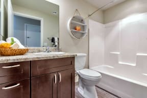 a bathroom with a toilet sink and bathtub at Allora Phoenix Apartments, Arizona