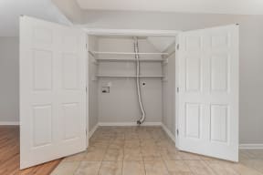 a bedroom with two closets and a tiled floor