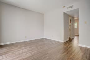 a bedroom with hardwood flooring at the oxford at estonia apartments in san an