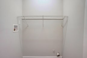 a small bathroom with a white shower and white walls