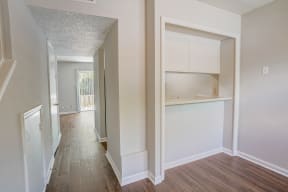 a bedroom with a medium hardwood floor and white walls