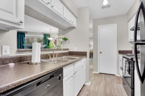 a kitchen with granite counter tops and a stainless steel sink at Madison Brookhaven, Atlanta