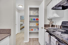 a kitchen with white cabinets and a stove and a refrigerator at Madison Brookhaven, Georgia