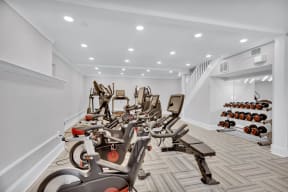 a gym filled with cardio bikes and dumbbells at Madison Brookhaven, Atlanta