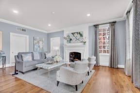 a living room with two couches and chairs and a fireplace at Madison Brookhaven, Georgia