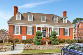 a red brick house with a front porch and a fountain at Madison Brookhaven, Atlanta