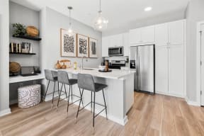 an open kitchen with a bar and a refrigerator