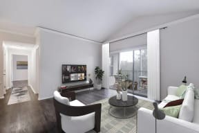 a living room with white furniture and a large window