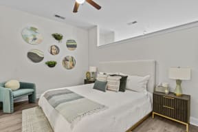 a bedroom with a large bed and a ceiling fan