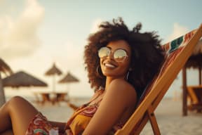 a woman sitting in a beach chair on the beach