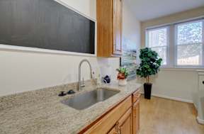 A kitchen with a sink and a window.