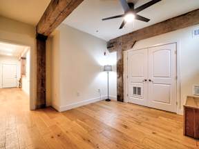 A room with wooden floors and a ceiling fan.