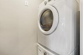 A white washing machine in a laundry room.