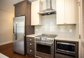 A modern kitchen with stainless steel appliances and wooden cabinets.