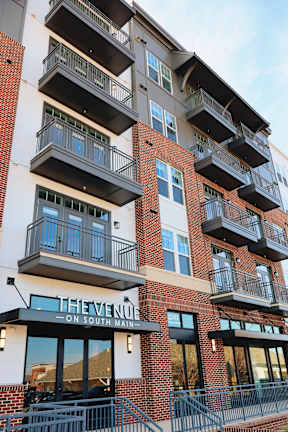 The Venue on South Main is a multi-story apartment building with balconies and large windows.