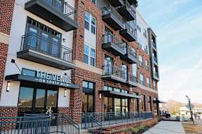 The Venue on South Main is a red brick building with black railings and balconies.