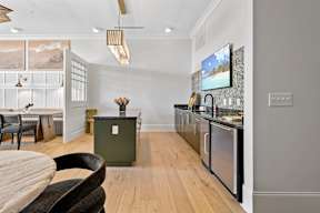 A modern kitchen with a wooden table and chairs.