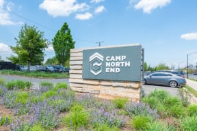 neighborhood North End Apartments  the sign for camp north end at the entrance to the parking lot