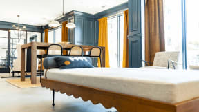 a large bed in a room with a table and chairs at The Fitzgerald, Spartanburg, South Carolina