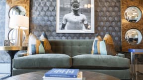 a living room with a couch and a table with a lamp and a picture on the wall at The Fitzgerald, Spartanburg
