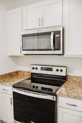 A black oven and microwave in a kitchen.