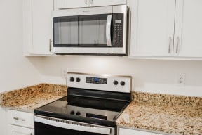 a kitchen with a stove and a microwave