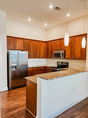 a kitchen with stainless steel appliances and a granite counter top