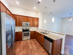 a kitchen with wooden cabinets and stainless steel appliances