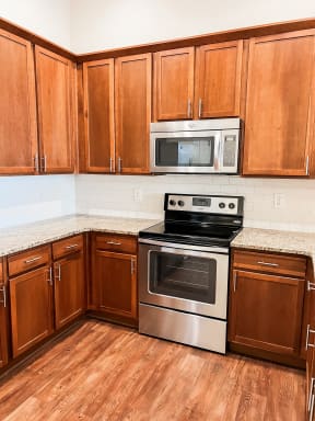 a kitchen with wooden cabinets and stainless steel appliances