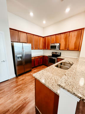 a kitchen with granite counter tops and stainless steel appliances