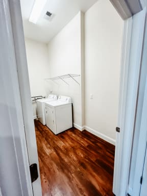 a small laundry room with two washes and a dryer in it
