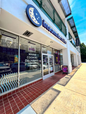 a view of the front of a store with a sign in the window