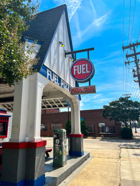 a fuel gas station with a fuel sign on the side of a building