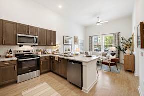 A modern kitchen with a large island and stainless steel appliances.