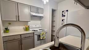 A kitchen with a stove, oven, and sink.
