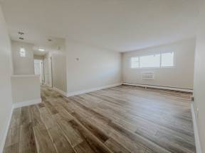 Spacious Living Room With Plank Flooring at Emerald Village Apartments, Willoughby