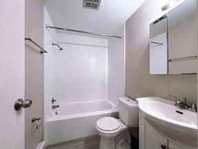 a bathroom with a toilet and a sink and a tub