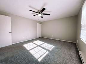 an empty room with a ceiling fan in it