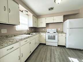 a kitchen with appliances and white cabinets