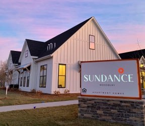 Exterior of the Clubhouse with Monument Sign at Dusk