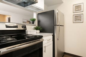 Fully Equipped Kitchen with Stainless Steel Appliances and White Cabinetry
